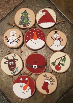 twelve wooden christmas ornaments are arranged in a circle on a table with a tree and snowman