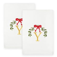 two white towels with red bows and the letter y printed on them, both have gold letters