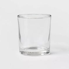 an empty glass on a white surface with no one around it, and the bottom half is