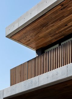 the side of a building with wooden slats on it's sides and a sky background