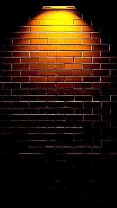 a brick wall with a light shining on it