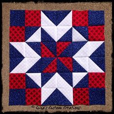 a red, white and blue quilt is shown