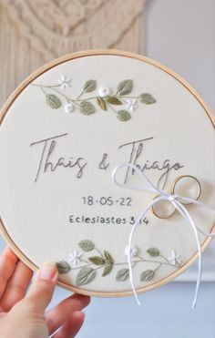 a person holding up a embroidery hoop with the words, thats and things on it