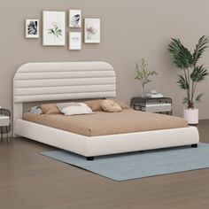 a white bed sitting on top of a wooden floor