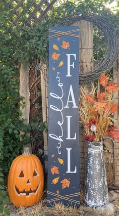 a wooden sign that says fall is next to some pumpkins and flowers in vases