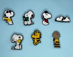 a group of cartoon pins sitting on top of a blue surface