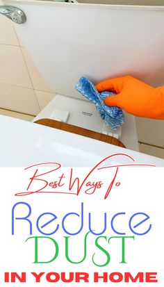 a person in orange gloves is cleaning a toilet