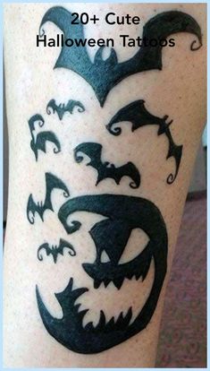 a halloween tattoo with bats and pumpkins on it