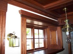 a window in a room with wooden paneling