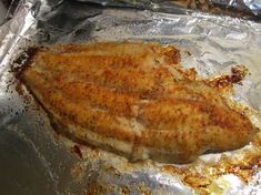 a piece of fish that is sitting on some tin foil