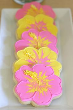 pink and yellow decorated cookies on a white plate