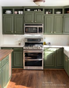 a kitchen with green cabinets and stainless steel stove top oven in the center, surrounded by wooden flooring