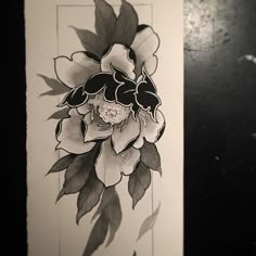 a black and white drawing of a flower