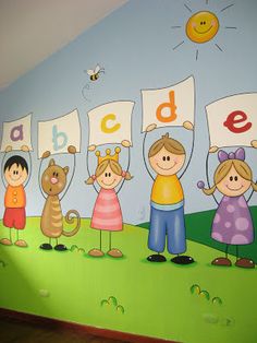 the children are holding up their abc and letter signs on the wall in the room