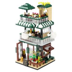 a lego model of a building with lots of furniture and decorations on top of it