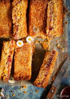 several pieces of cake sitting on top of a table next to a knife and fork