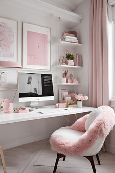 a white desk topped with a computer monitor next to a pink chair