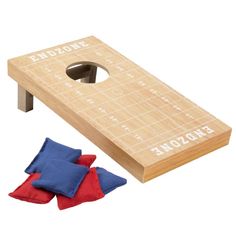 a bean bag toss game with two red and blue mitts next to the board