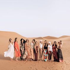 a group of women standing in the desert