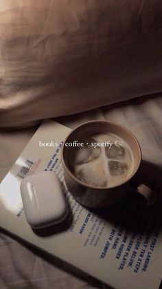 a cup of coffee sitting on top of a book