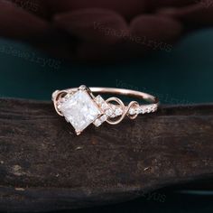 a white diamond ring on top of a piece of wood