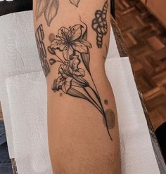 a person with a flower tattoo on their arm