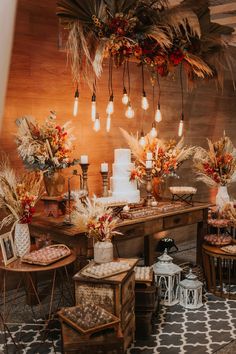 a table with many different types of food on it and some lights hanging from the ceiling