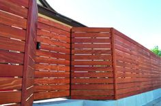 a wooden fence next to a building