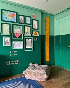 a room with green walls and pictures on the wall