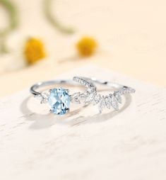 a ring with an aqua blue stone surrounded by diamonds