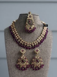 a necklace and earring set on display