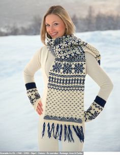 a woman standing in the snow with her hands on her hips and wearing a scarf