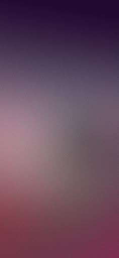 a blurry image of an airplane flying in the sky with pink and purple hues