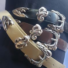 "This vintage silver ladies Wstern belt buckle set has a unique design engraved in it. This set includes one buckle one keeper and a belt tip. receive a free belt with every buckle set purchase. belts come in three colors cream, black, and brown.  sorry I only have the following size belts left 32\" in all colors and 36\" in brown only" Luxury Vintage Brass Belt Buckle, Formal Adjustable Belt With Antique Buckle, Vintage Belt Buckles With Belt For Gift, Elegant Silver Belt Buckles With Removable Belt, Adjustable Antique Silver Belt Buckles, Elegant Adjustable Belt Buckles With Brass Buckle, Elegant Adjustable Belt Buckle With Brass Detail, Elegant Adjustable Belts With Silver Buckle, Elegant Adjustable Belt With Silver Buckle