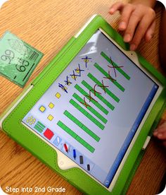 a child is playing with an electronic tablet