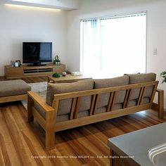 a living room filled with furniture and a flat screen tv on top of a wooden table