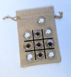 a tic - tac - toe game is displayed on a linen bag