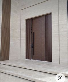 an open door on the side of a building with steps leading up to it's entrance