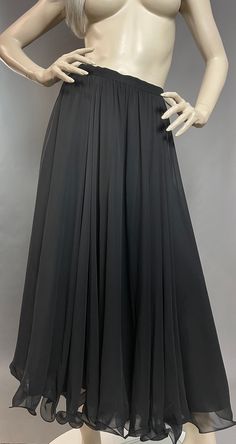 "Frank Usher Skirt | Black Chiffon Skirt | 90s Maxi Skirt I simply love Frank Usher designs - they are renowned for their flowing gowns, cocktail dresses and evening wear, producing some of the finest designs during the 50s, 60s and 70s. This striking skirt is no exception to the rule, team it with a bodysuit, jumper or T-shirt - it just makes an outfit! Easy breezy to allow for freedom of movement and complete comfort. An absolutely delicious addition to your wardrobe... (Please note jumper/bod Evening Midi Dress With Ruffled Skirt, Evening Dress With Ruffled Midi Skirt, Flowy Pleated Skirt For Cocktail, Evening Pleated Full Maxi Skirt, Fitted Long Pleated Evening Skirt, Fitted Pleated Maxi Skirt For Evening, Fitted Ruffled Maxi Skirt For Prom, Elegant Chiffon Pleated Skirt For Party, Evening Maxi Skirt With Gathered Detail