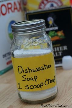 a jar filled with dishwasher soap on top of a wooden table