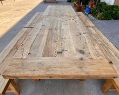 a wooden table sitting on top of a sidewalk