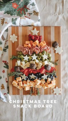 a christmas tree made out of crackers on top of a cutting board with the words christmas tree snack