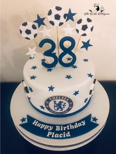 a birthday cake with the number 28 on top and stars around it is decorated in blue and white