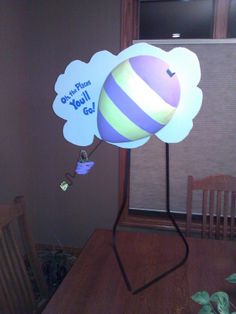 a light up balloon sitting on top of a wooden table