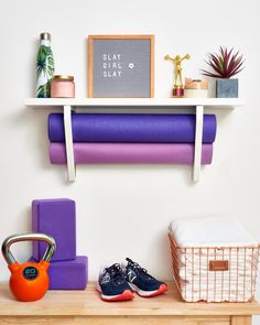 there is a shelf with yoga mats and other items on it, along with a pair of shoes