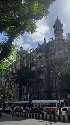 an old building with cars parked in front