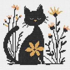 a black cat sitting on top of a field of flowers next to tall yellow leaves