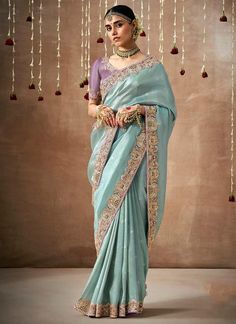 Elevate your bridal look with our sky blue saree, adorned with intricate sequins and organza silk. The elegant contrast lavender blouse, featuring intricate embroidery, adds a touch of sophistication to your wedding ensemble. Perfect for the stylish bride looking to make a statement. The unstitched blouse can be customized upto 44 inches. Do Note: All the accessories shown are for styling purpose only. Slight color variation may occur due to photographic reasons. Fall and Pico : Done Draping Sar Saree Matching Blouse, Drapping Saree, Blue Organza, Saree Embroidery, Organza Silk Saree, Designer Silk Sarees, Embroidered Organza, Blue Saree, Fancy Blouses