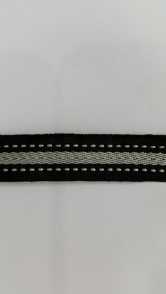 a black and white striped ribbon with holes