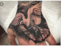 a person's hand with a bird tattoo on it, and an eagle flying in the sky